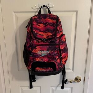 Speedo Teamster 35L backpack lightly used. EUC. Red/orange/purple w/black trim.